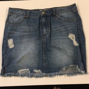 Distressed denim mini skirt. Light wash